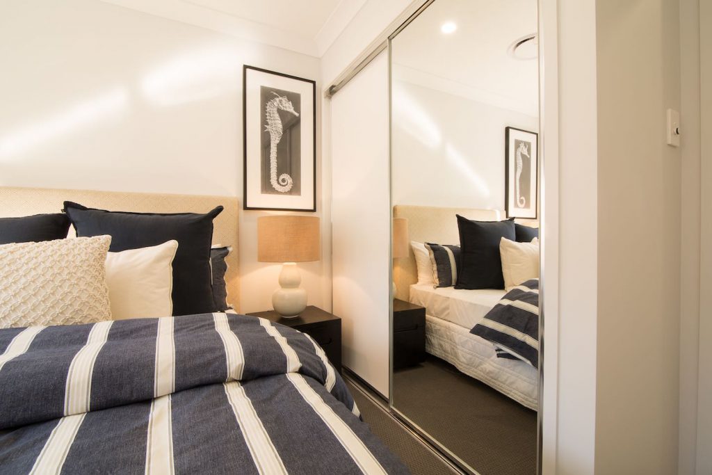 bedroom built in wardrobe across from a bed